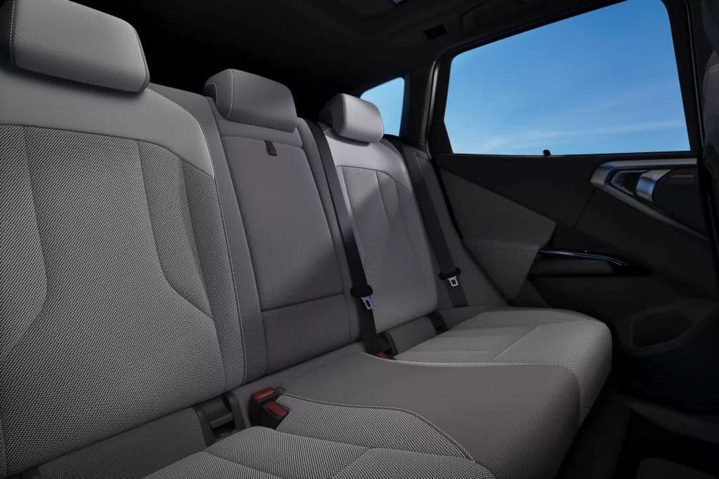 Gray upholstered rear car seats with headrests and seatbelts visible.